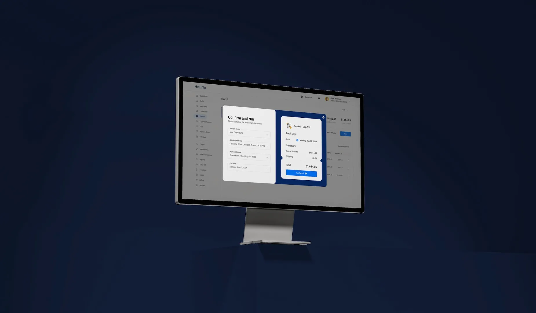 A monitor on a deep navy backdrop showing the payroll confirm-and-run screen with its summary panel.